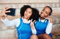 Sports, friends and selfie by netball team on steps with smile, hand and peace sign, happy and relax. Social media, girl