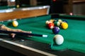 Sports game of billiards on a green cloth. Billiard balls with numbers on a pool table. Royalty Free Stock Photo