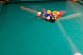 Sports game of billiards on a green cloth. Multi-colored billiard balls with numbers Royalty Free Stock Photo