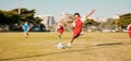 Sports game, soccer and child shooting, kick or strike ball to score winning goal in contest, competition or match Royalty Free Stock Photo