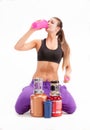 Sports girl with a cans of a protein and BCAA