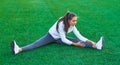 Sports girl doing morning gymnastics workout on a football field. Fitness, sport, health energy. Royalty Free Stock Photo
