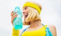 Sports girl drinks water from a bottle on a sky background. Drinking during sport. Healthy lifestyle concept. Woman in Royalty Free Stock Photo