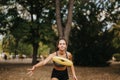 Sporty girls enjoying a sunny day in the park, playing frisbee and training outdoors, surrounded by nature. Royalty Free Stock Photo