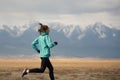Sports girl jogging on the background of mountains