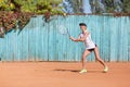 Sports girl playing badminton on the outdoors background. Active lifestyle concept. Copy space. Royalty Free Stock Photo