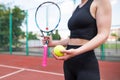 Sports girl is preparing to serve a tennis ball. Close-up of a beautiful young girl holding a tennis ball and racket Royalty Free Stock Photo