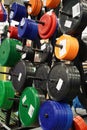 Sports goods sale in store,colorful weight plates.Healthy lifestyle concept,sports training.Close-up colorfull barbell plates