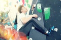 Teen guy practicing rock climbing on climbing wall Royalty Free Stock Photo