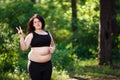 Portrait of young overweight woman running outdoors demonstratin Royalty Free Stock Photo