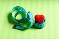 Sports and healthy lifestyle concept. Heart decoration and flexible ruler Royalty Free Stock Photo