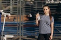 Sports and healthy lifestyle. Sports girl at an outdoor workout in a park on the sports field. Woman is drinking a water Royalty Free Stock Photo