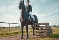 Sports, horse and equestrian with a woman jockey riding outdoor on a farm or ranch for horseback training. Nature Royalty Free Stock Photo
