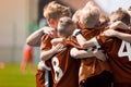 Sports Huddle; Children Sports Soccer Team. Kids Celebrating Football Victory. Winning Youth Boys Soccer Team