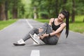 Sports Injury. Asian Girl Suffering From Ankle Pain After Jogging In Park Royalty Free Stock Photo