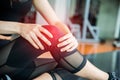 Sports injury at knee in fitness training gym. Training and medical concept. Health care and Sport exercise concept. Pain of body