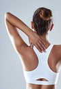 Sports injury, woman and back pain for fitness, workout and wellness in studio. Hurt, athlete and thoracic spine with