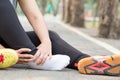 Sports injury. Woman with pain in ankle while jogging