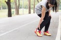 Sports injury. Woman with pain in ankle while jogging Royalty Free Stock Photo