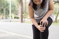 Sports injury. Woman with pain in knee while jogging