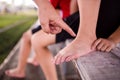 Sports injury. Youth soccer player in ankle pain. Doctor perform checking and first aid at knee trauma. Royalty Free Stock Photo