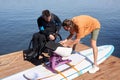 Sports instructor assembling adaptive wakeboarding equipment