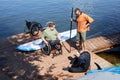 Sports instructor giving demonstration on water sports and adaptive equipment