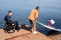 Sports instructor putting adaptive board in water