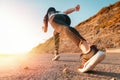 Sports and Jogging along the sea. The woman stands ready to run. In the background, the mountain and the sun. Bottom view Royalty Free Stock Photo