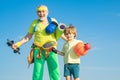 Sports for kids. Father and son sporting - family time together. Senior man and cute little boy exercising on blue sky Royalty Free Stock Photo