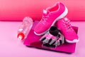 Sports kit for weight control before fitness training and after, on a pink background Royalty Free Stock Photo