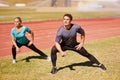 Sports, legs and people stretching at stadium for race, marathon or competition training for health. Fitness, energy and Royalty Free Stock Photo
