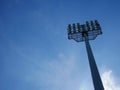 Sports light pole or Stadium Light tower in sport arena on blue sky with clouds. Royalty Free Stock Photo