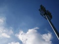 Sports light pole or Stadium Light tower in sport arena on blue sky with clouds Royalty Free Stock Photo