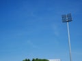 Sports light pole or Stadium Light tower in sport arena on blue sky with clouds. Royalty Free Stock Photo