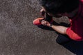 Sports male runner tying shoelaces. man lacing her sneakers on a stadium running track. Workout outdoors concept Royalty Free Stock Photo