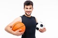 Sports man holding basketball and soccer ball Royalty Free Stock Photo