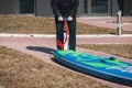 Sports man inflates pump paddle Board, Royalty Free Stock Photo