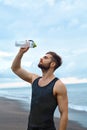 Sports Man Pouring Water Over Face After Workout At Beach. Royalty Free Stock Photo