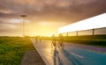 Sports man ride bicycles on the road in the evening near blank advertising billboard with sunset sky. Summer outdoor exercise for