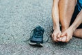 Sports man runner with injured foot while training on the asphalt road . Healthcare, medicine and people concept. Royalty Free Stock Photo