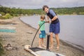 Sports man inflates pump paddle Board, fashionable modern entertainment Royalty Free Stock Photo