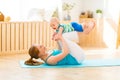 Sports mother is engaged in fitness and yoga with baby at home Royalty Free Stock Photo