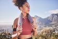 Sports, music and woman running in nature, stop for rest with view of mountain and city, relax and calm. Radio, fitness Royalty Free Stock Photo