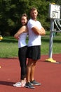 Young sports people in sportswear pose on the street.