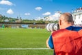 Sports photographers and journalists recorded during the game on the football field