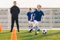 Sports physical education lesson. Children training soccer football on schools field. School athletic activities Royalty Free Stock Photo