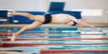 Sports, pool and male athlete diving for training, exercise or competition for indoor swimming. Fitness, action and Royalty Free Stock Photo