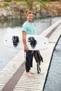 Sports, portrait and man by lake with wakeboard for surfing, exercise and recreation hobby outdoors. Fitness, extreme Royalty Free Stock Photo