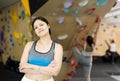 Sports positive woman climber on background of climbing wall